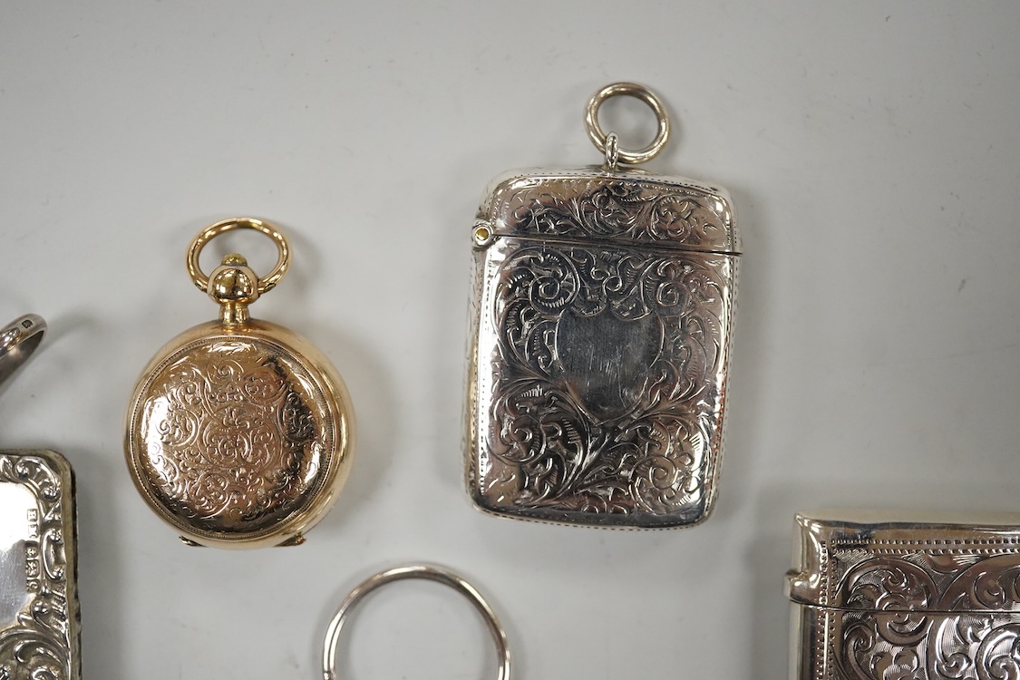 Two late Victorian silver twin compartment sovereign cases, Birmingham, 1891 & 1896, both approx. 57mm, a gold plated sovereign case, together with three silver vesta cases, a silver purse and a silver mounted notebook.